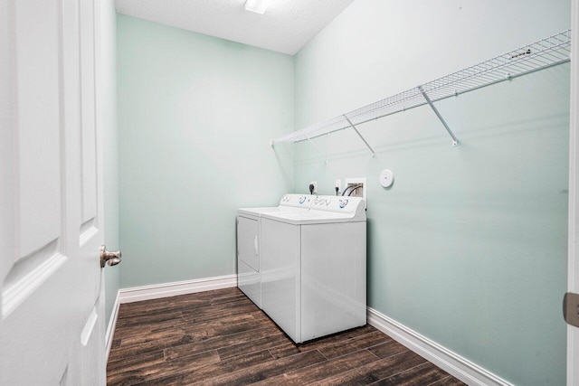 clothes washing area with a textured ceiling and washing machine and clothes dryer