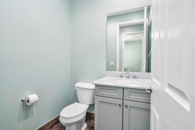 bathroom featuring vanity and toilet