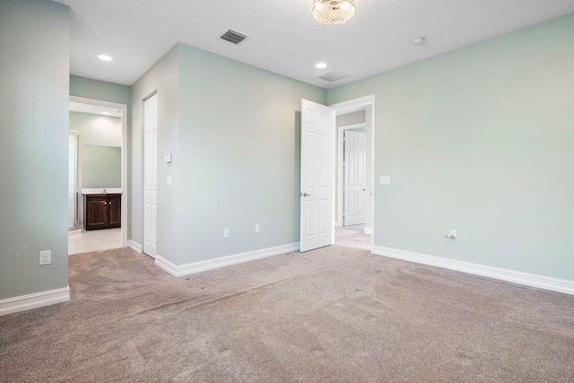 unfurnished bedroom with light colored carpet