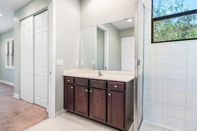 bathroom with tile patterned floors, vanity, and a shower with shower door