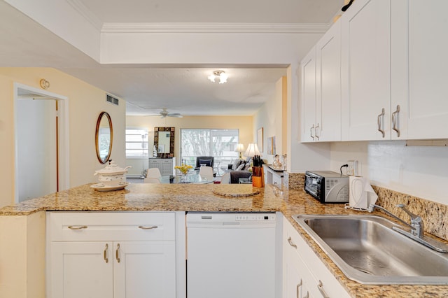 kitchen with white dishwasher, white cabinets, kitchen peninsula, and sink