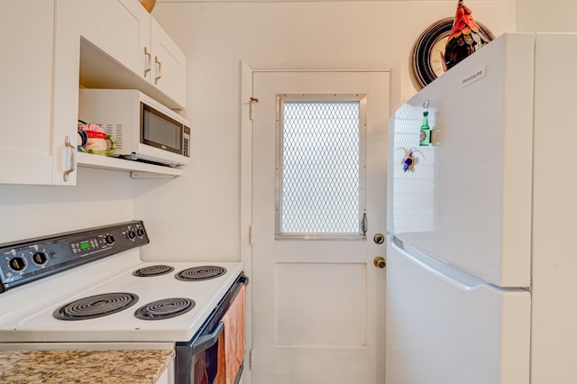 kitchen featuring white appliances, white cabinetry, and light stone counters