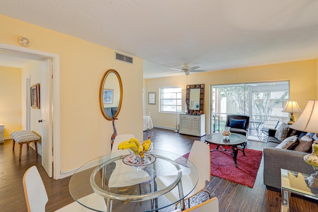 living room with ceiling fan and dark hardwood / wood-style flooring