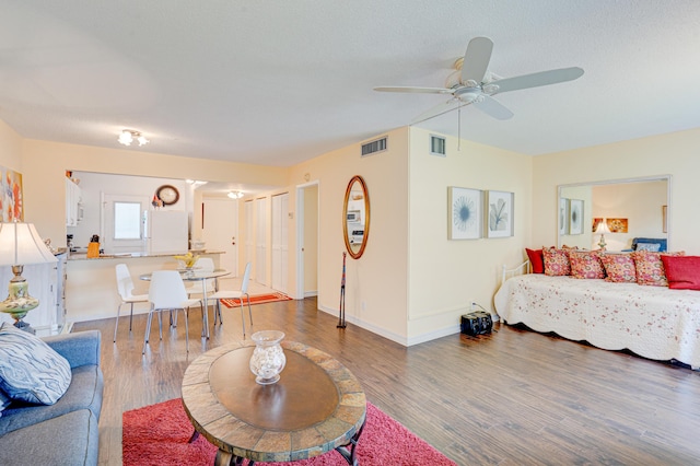 living room with hardwood / wood-style flooring and ceiling fan