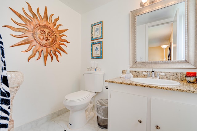 bathroom featuring tile patterned flooring, vanity, and toilet