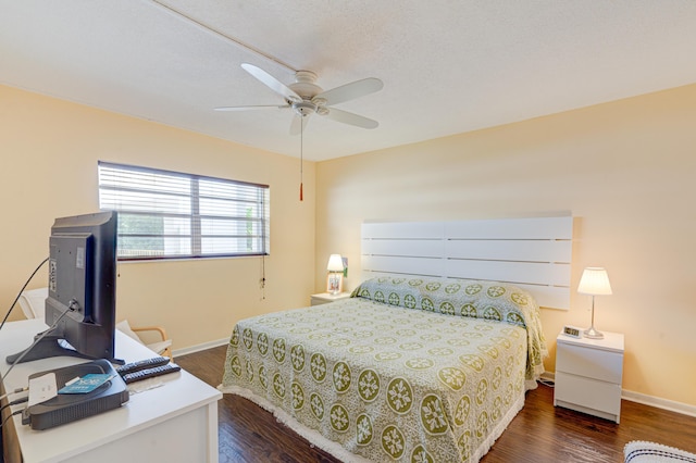 bedroom with dark hardwood / wood-style flooring and ceiling fan