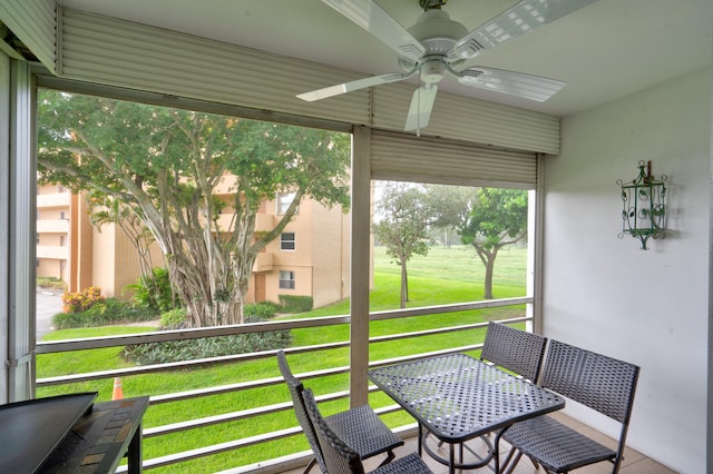 sunroom featuring ceiling fan