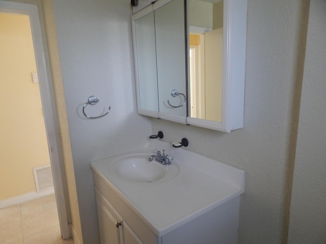 bathroom with tile patterned flooring and vanity