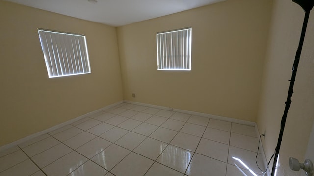 unfurnished room with light tile patterned floors