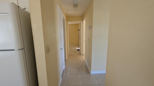 hall with light tile patterned flooring