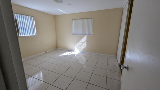 empty room with light tile patterned flooring