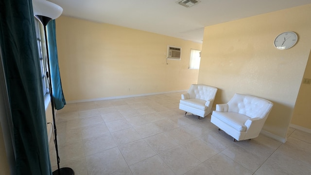 unfurnished room featuring light tile patterned flooring and a wall unit AC