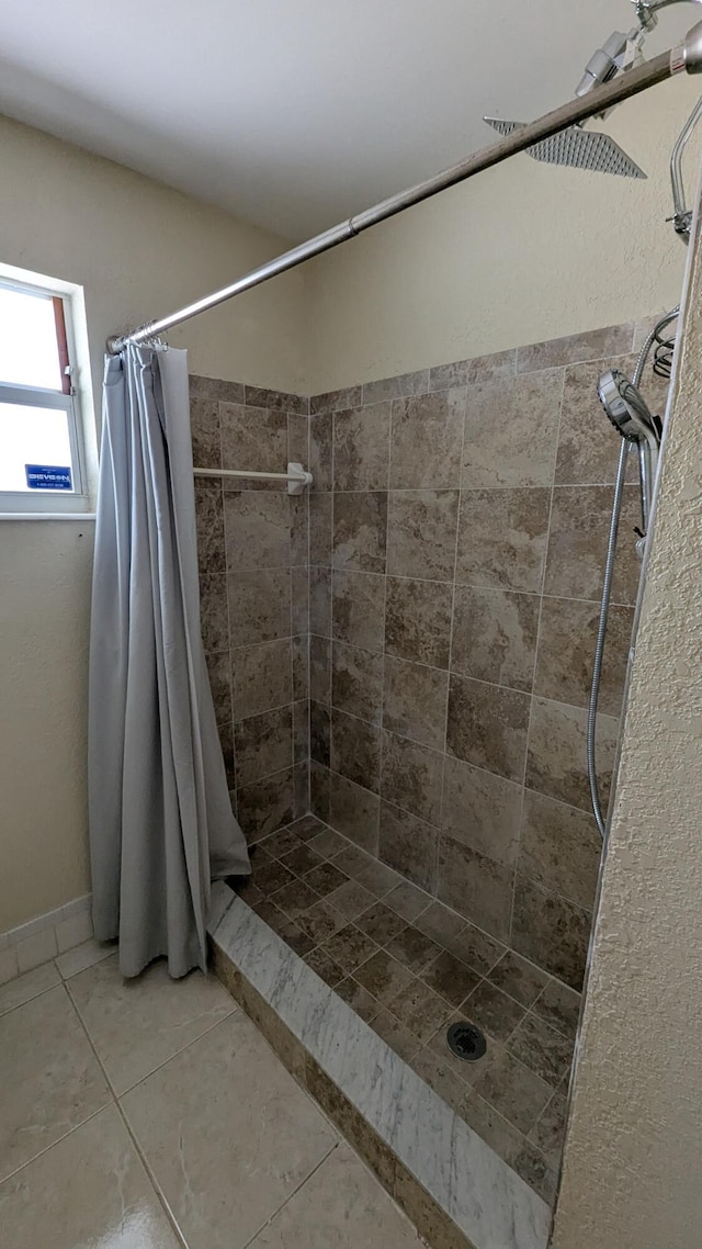 bathroom featuring tile patterned floors and curtained shower