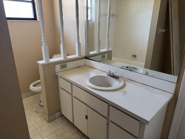 bathroom with tile patterned floors, vanity, and toilet