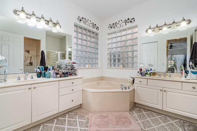 bathroom featuring tile patterned floors, vanity, and shower with separate bathtub