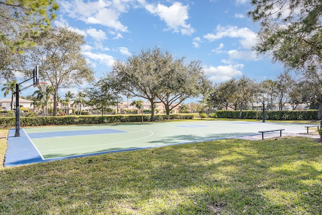 view of sport court featuring a lawn