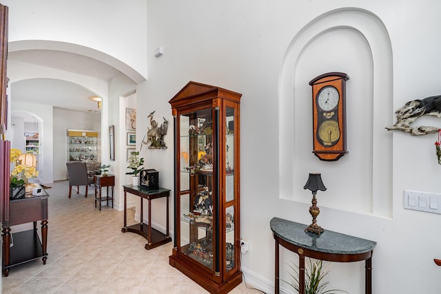 hall with light tile patterned floors