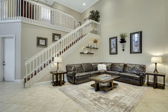 tiled living room featuring ornamental molding and a towering ceiling