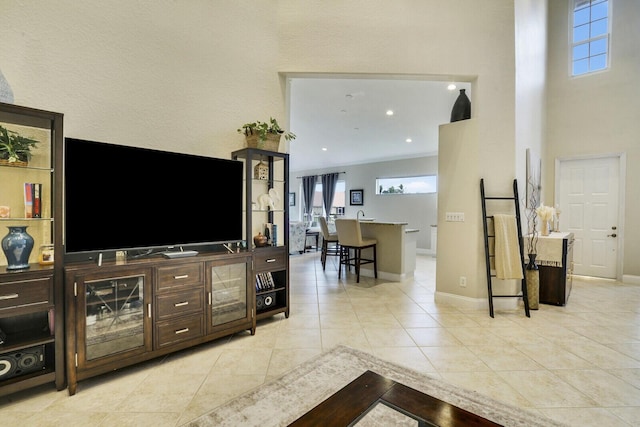 tiled living room with a towering ceiling