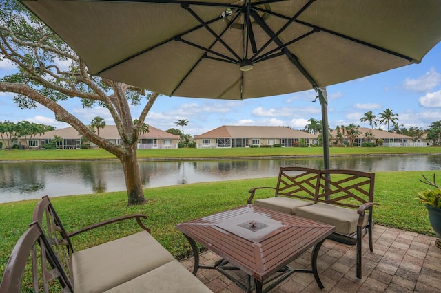 view of patio featuring a fire pit and a water view