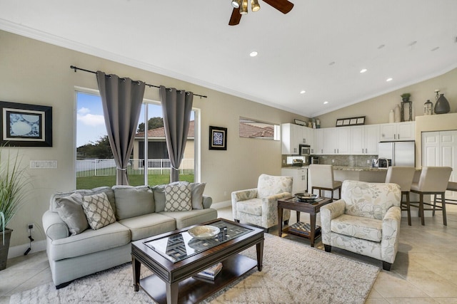 tiled living room featuring ceiling fan, ornamental molding, and lofted ceiling