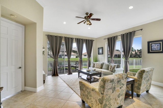 living room with ceiling fan, light tile patterned floors, and crown molding