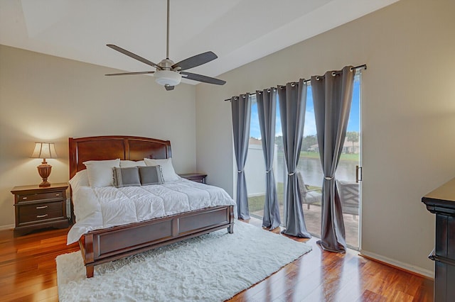 bedroom with ceiling fan, access to exterior, and hardwood / wood-style flooring