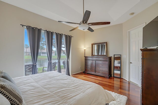 bedroom featuring ceiling fan, access to exterior, and hardwood / wood-style floors