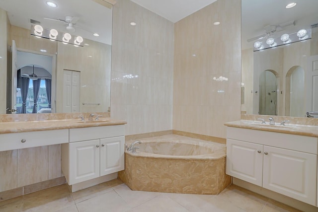 bathroom featuring ceiling fan, tile patterned flooring, and tile walls