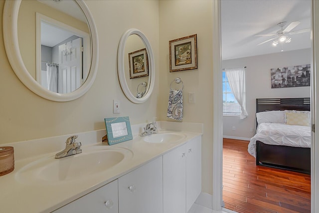 bathroom with ceiling fan, vanity, and hardwood / wood-style flooring