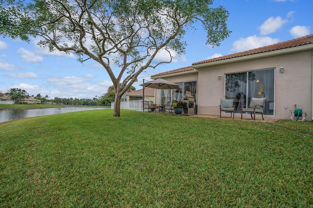 view of yard with a patio area and a water view