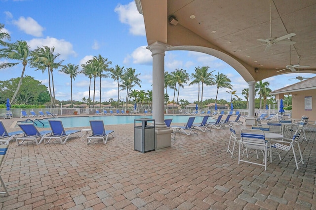 view of patio / terrace with ceiling fan and a community pool