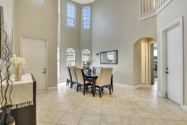 tiled dining room featuring a high ceiling