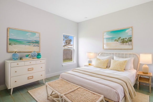 bedroom with dark hardwood / wood-style flooring