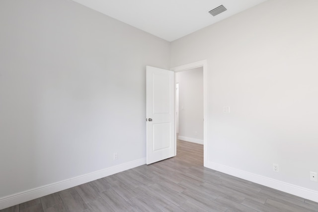 unfurnished room with light wood-type flooring