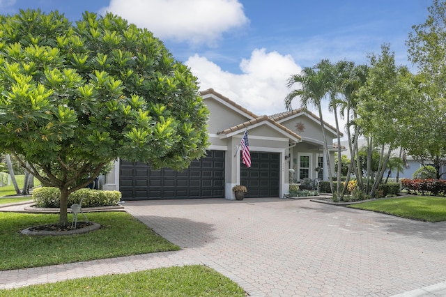 view of front of property featuring a garage and a front yard