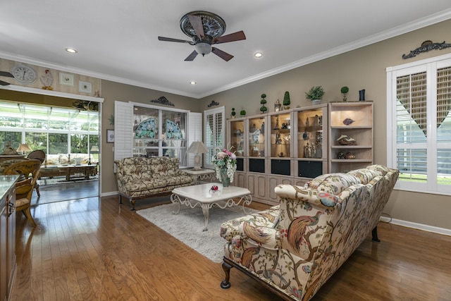 living room with ceiling fan, wood-type flooring, and ornamental molding