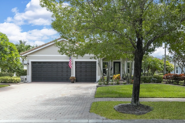 view of front facade with a garage and a front lawn