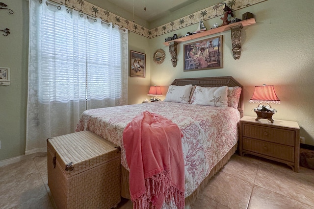 bedroom with light tile patterned floors