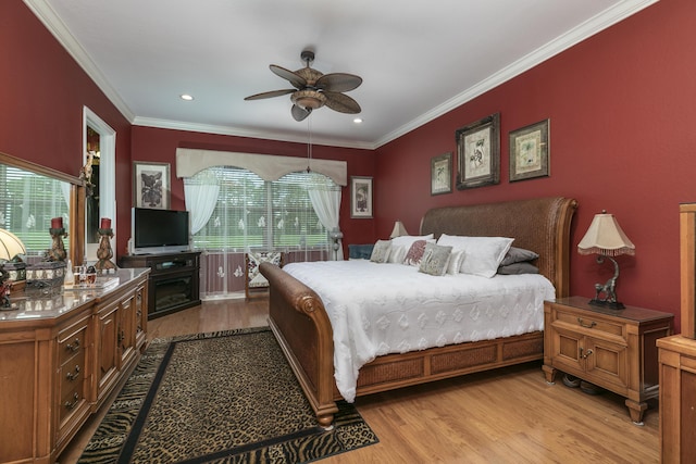 bedroom with multiple windows, ceiling fan, light hardwood / wood-style flooring, and crown molding