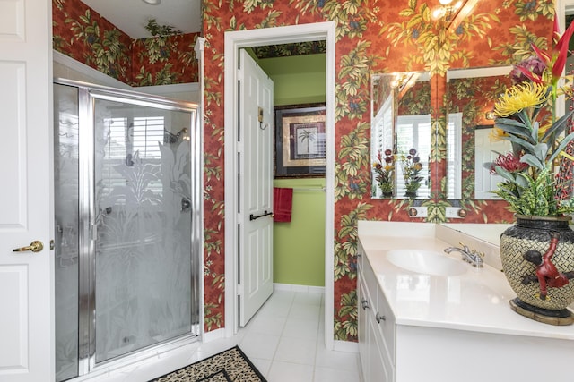 bathroom with tile patterned floors, vanity, and walk in shower