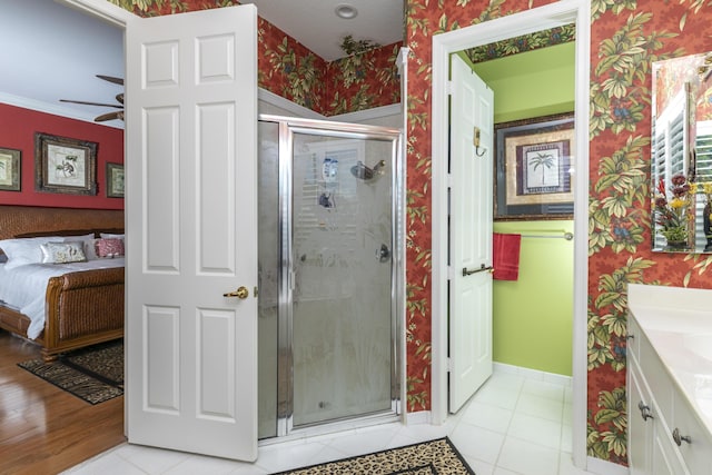 bathroom featuring tile patterned floors, crown molding, vanity, and an enclosed shower