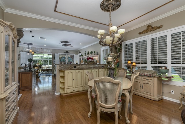 dining room featuring sink, ceiling fan with notable chandelier, dark hardwood / wood-style flooring, and crown molding