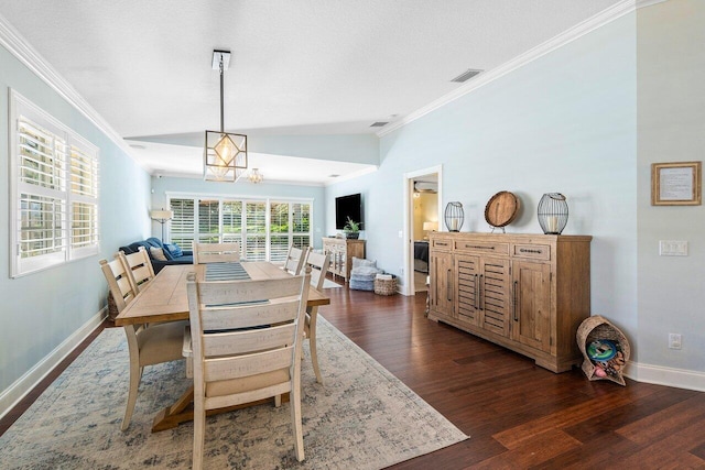 dining space with dark wood-type flooring, lofted ceiling, and ornamental molding