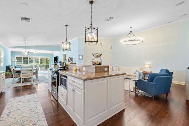 kitchen featuring decorative light fixtures, a kitchen island, stainless steel electric range oven, light stone countertops, and white cabinets