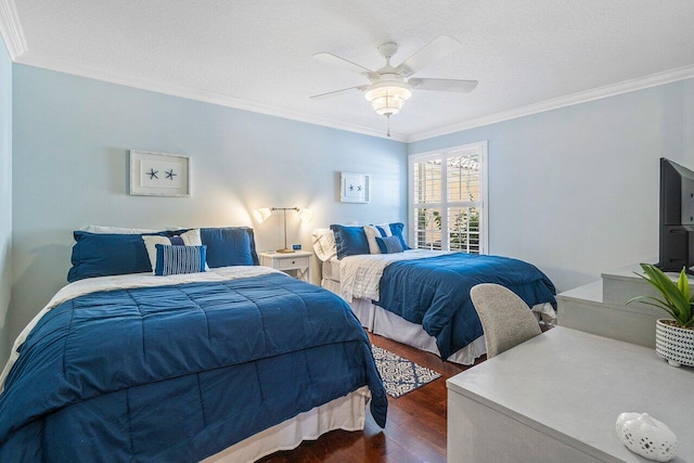 bedroom featuring ceiling fan, dark wood-type flooring, ornamental molding, and a textured ceiling