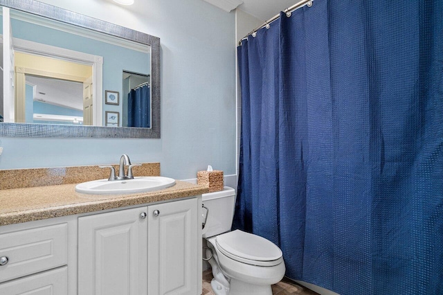 bathroom featuring toilet and vanity