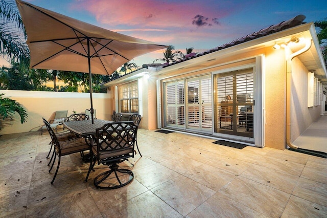 view of patio terrace at dusk