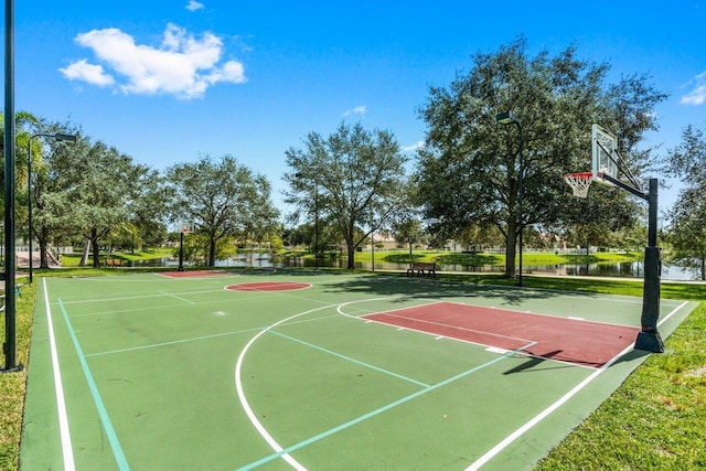 view of sport court with a water view