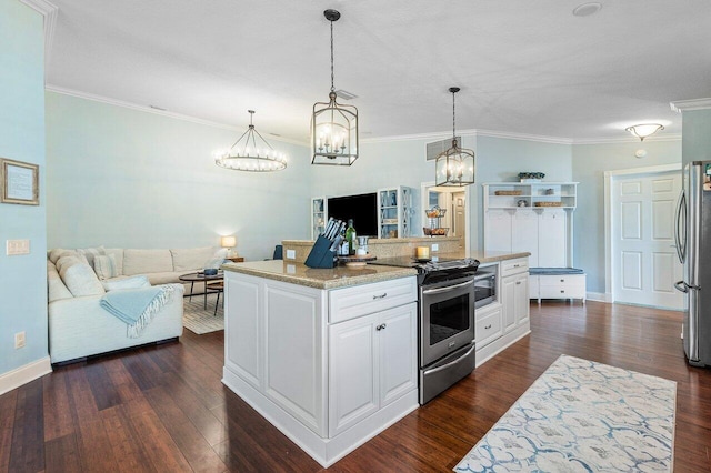 kitchen with white cabinets, pendant lighting, stainless steel appliances, and a center island